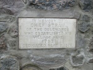 A plaque on the Chief Straw Monument reading "In memory of Chief Straw of the Delewares who establishes his village here. 1787. Dedicated Sept 9, 1928."