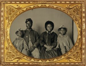 African American soldier in Union uniform with wife and two daughters